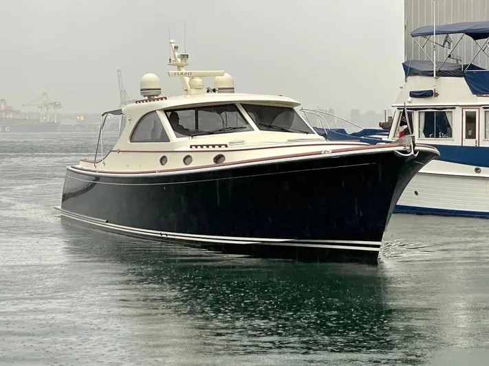 Flight Yacht Photos Pics 2009 San Juan 48 yacht on water, sleek design, overcast day.