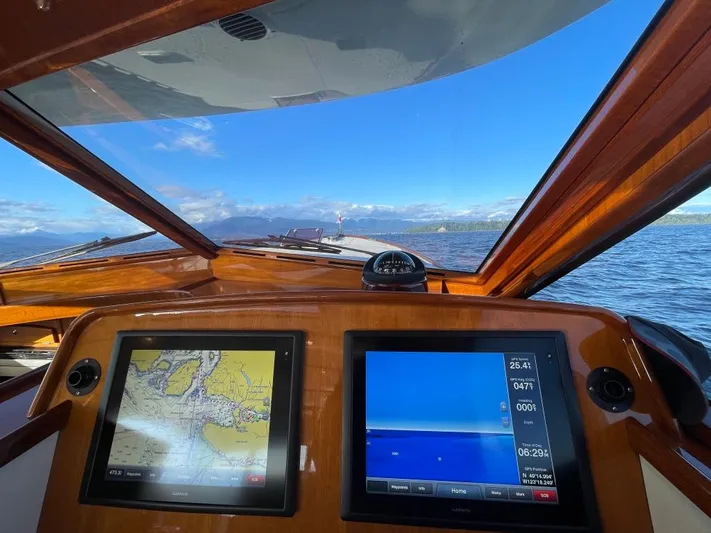 Flight Yacht Photos Pics Boat cockpit view with navigation screens, San Juan 48, 2009 model, clear blue sky and sea.