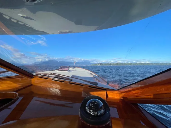 Flight Yacht Photos Pics View from a 2009 San Juan 48 yacht cockpit, overlooking serene waters and distant mountains.