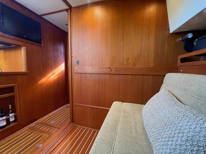 Flight Yacht Photos Pics Luxurious 2009 San Juan 48 yacht interior with wood paneling and cozy seating area.