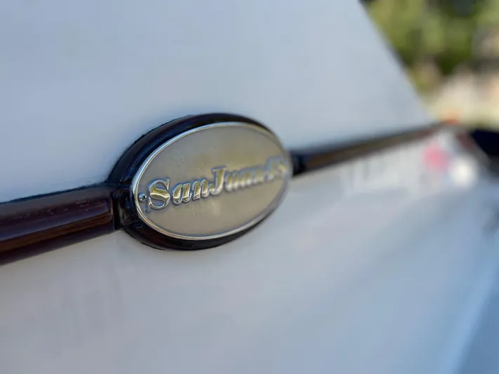 Flight Yacht Photos Pics Close-up of 2009 San Juan 48 emblem on a white surface.