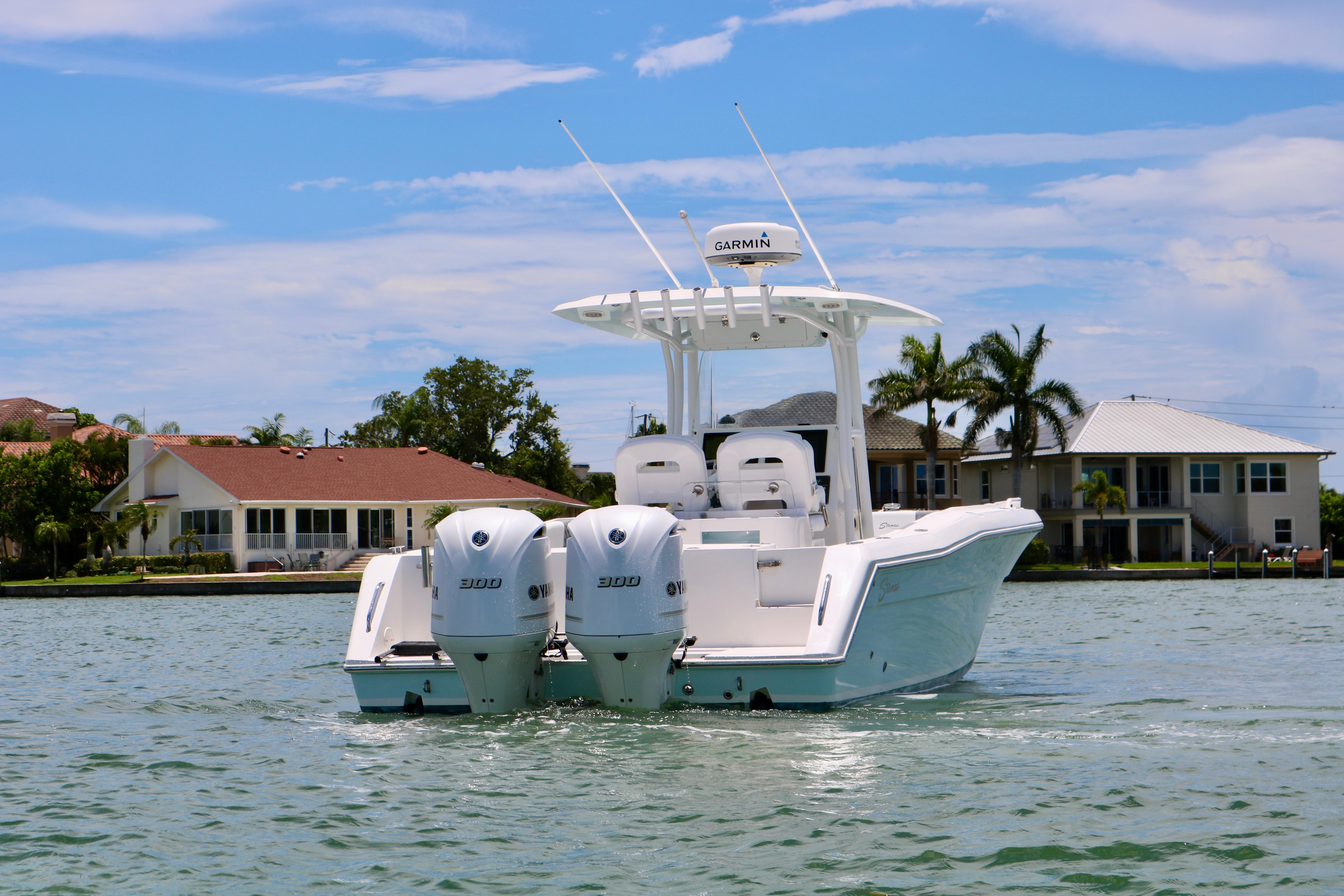 2016 Stamas 317 Tarpon boat with twin engines on a sunny day.