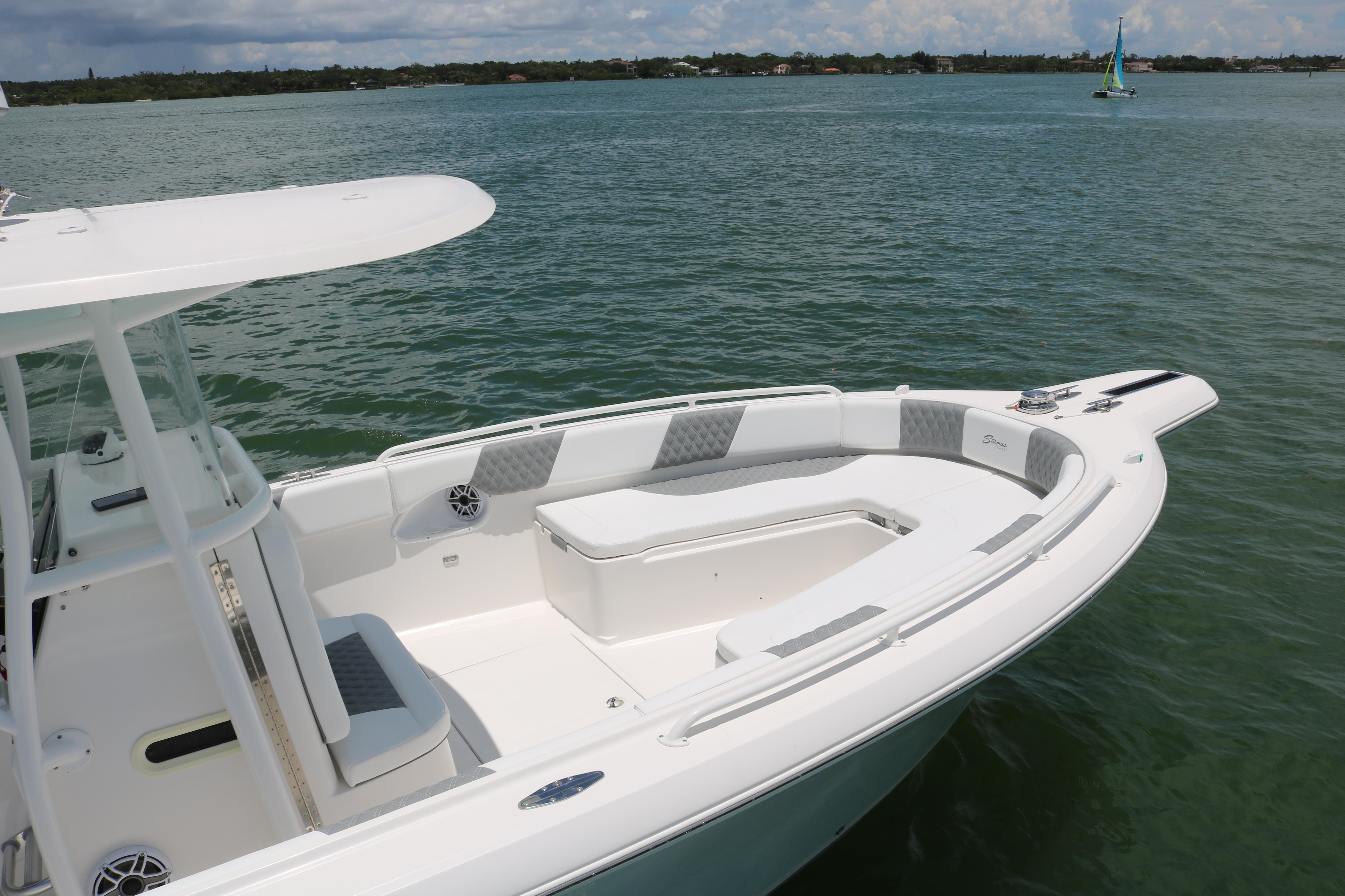 2016 Stamas 317 Tarpon boat on calm water with spacious seating area.