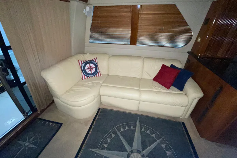 Yacht Photos Pics Luxurious interior of 2004 Carver 460 Voyager with cream leather sofa and nautical-themed decor.