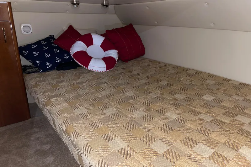  Yacht Photos Pics Cozy cabin bed in 2004 Carver 460 Voyager with nautical-themed pillows.