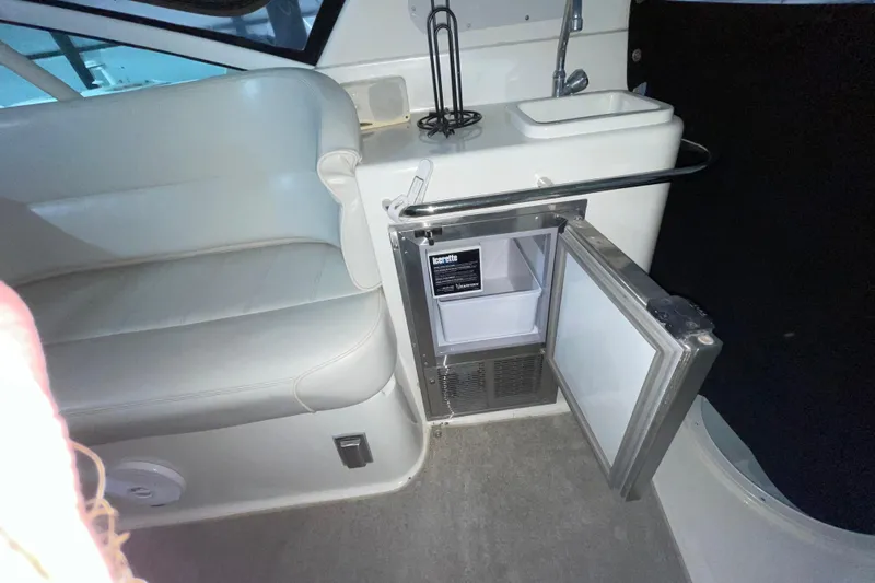  Yacht Photos Pics Interior of 2004 Carver 460 Voyager with open mini fridge and seating area.