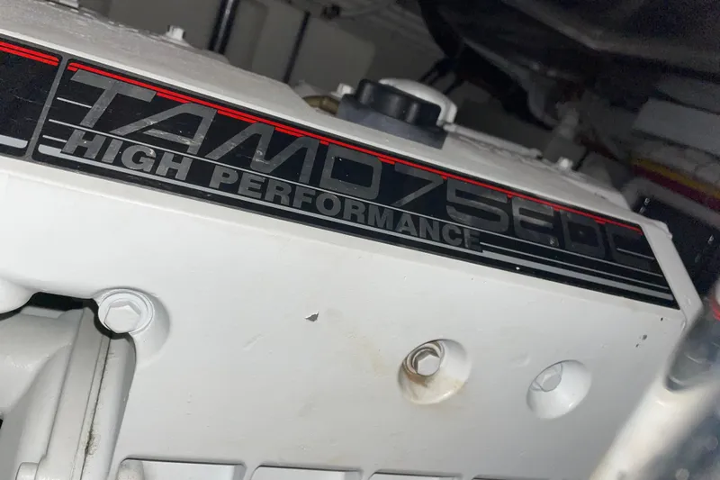  Yacht Photos Pics Engine detail of 2004 Carver 460 Voyager, featuring TAMD75EDC high-performance label.