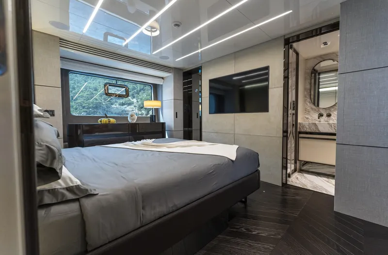 Orca I Yacht Photos Pics Luxurious bedroom interior of 2022 Cranchi Settantotto 78 yacht with modern design and elegant furnishings.