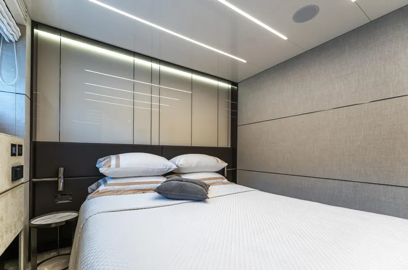 Orca I Yacht Photos Pics Luxurious bedroom interior on 2022 Cranchi Settantotto 78 yacht, featuring modern design and elegant bedding.