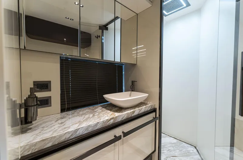 Orca I Yacht Photos Pics Luxurious bathroom interior on 2022 Cranchi Settantotto 78 yacht with marble countertop and modern fixtures.