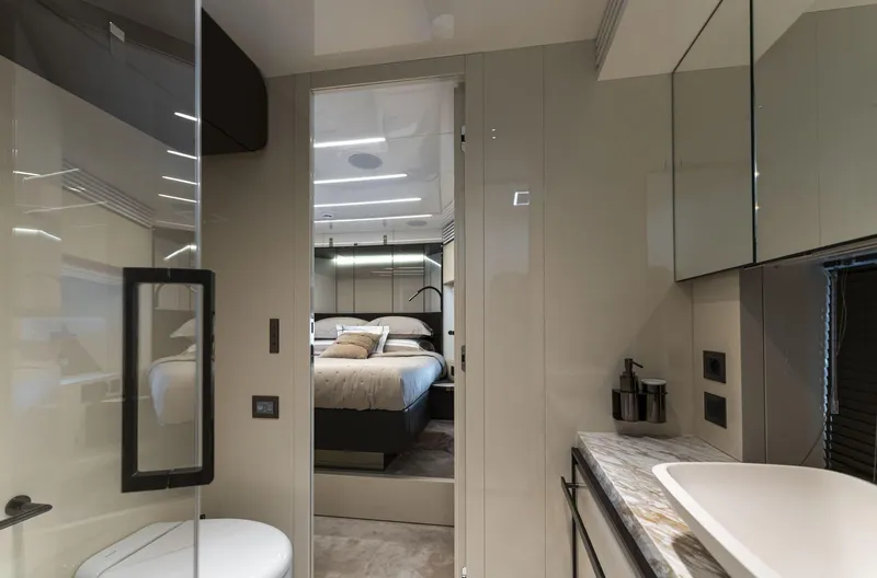 Orca I Yacht Photos Pics Luxurious interior of 2022 Cranchi Settantotto 78 yacht, featuring modern bedroom and bathroom design.