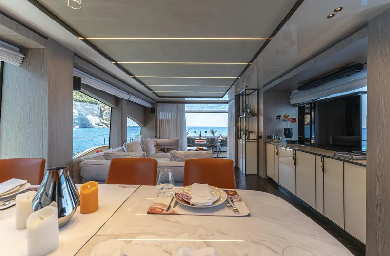 Orca I Yacht Photos Pics Luxurious interior of 2022 Cranchi Settantotto 78 yacht with elegant dining and lounge area.