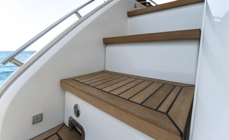 Orca I Yacht Photos Pics Staircase on 2022 Cranchi Settantotto 78 yacht with wooden steps and ocean view.