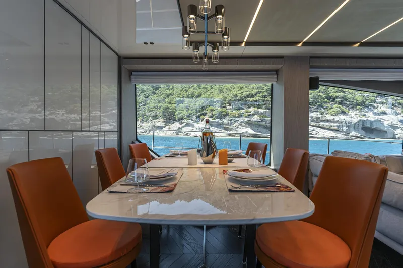 Orca I Yacht Photos Pics Luxurious dining area on 2022 Cranchi Settantotto 78 yacht with scenic ocean view.