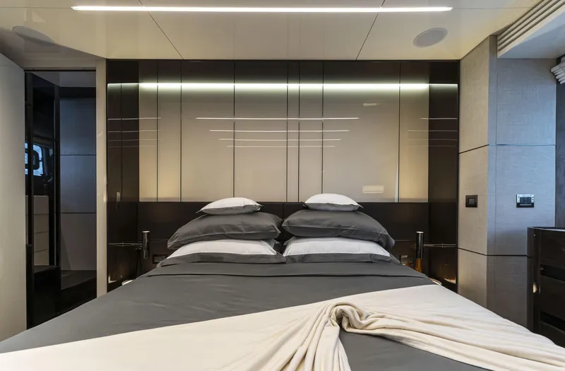 Orca I Yacht Photos Pics Luxurious bedroom interior on 2022 Cranchi Settantotto 78 yacht, featuring modern design and elegant bedding.