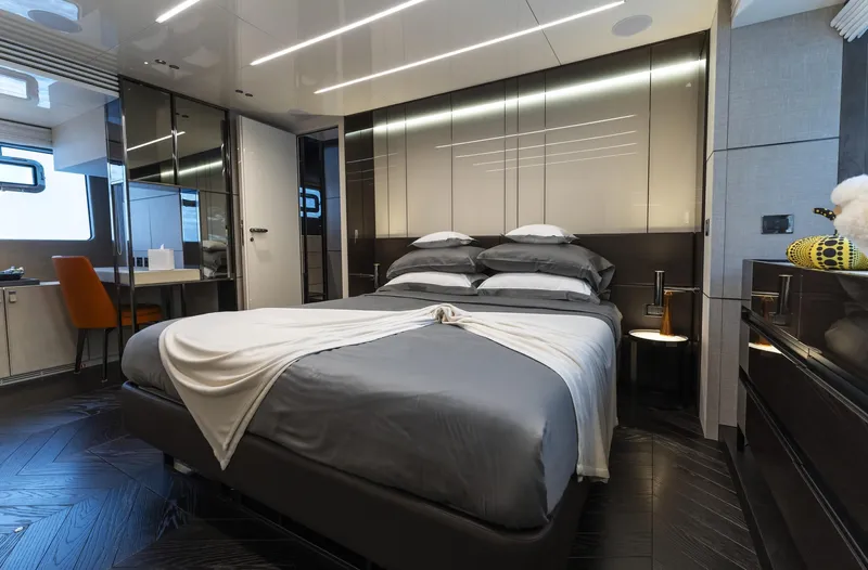 Orca I Yacht Photos Pics Luxurious bedroom interior of 2022 Cranchi Settantotto 78 yacht, featuring modern design and elegant furnishings.