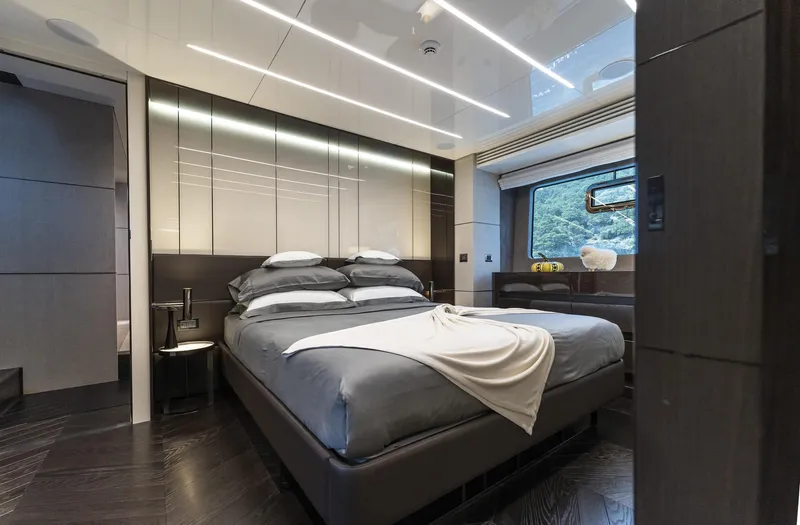 Orca I Yacht Photos Pics Luxurious bedroom interior on 2022 Cranchi Settantotto 78 yacht, featuring modern design and elegant furnishings.