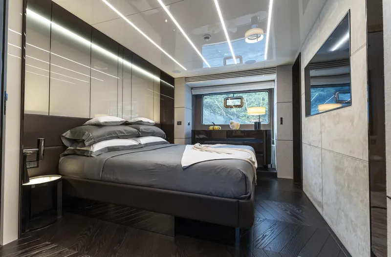 Orca I Yacht Photos Pics Luxurious bedroom interior of 2022 Cranchi Settantotto 78 yacht with modern design and elegant furnishings.