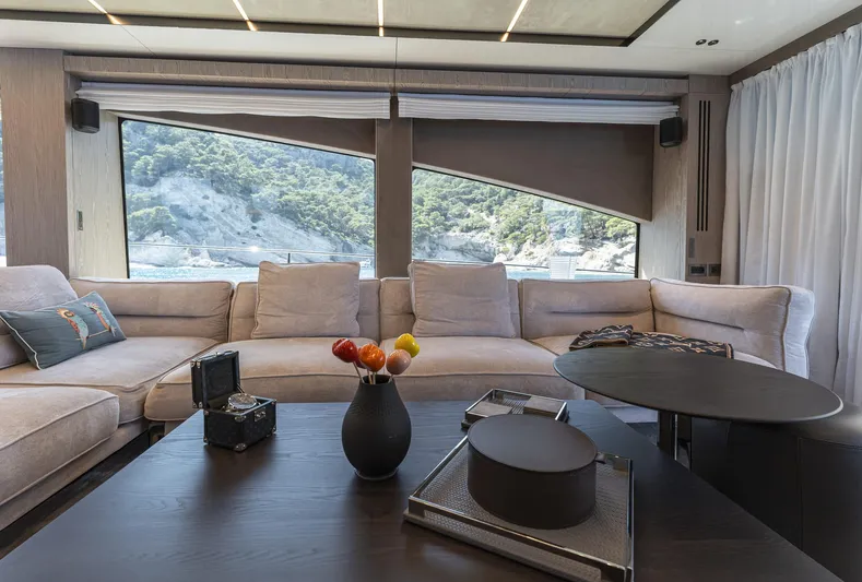 Orca I Yacht Photos Pics Luxurious interior of 2022 Cranchi Settantotto 78 yacht with modern furnishings and scenic window view.
