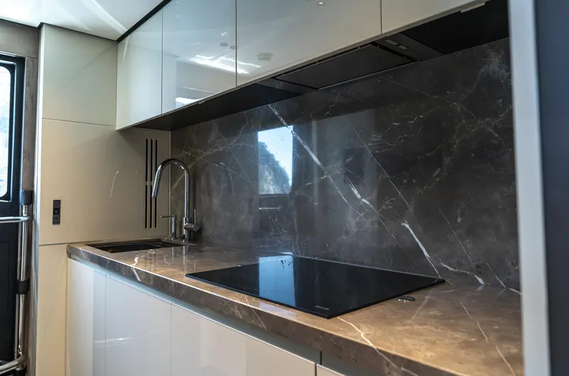 Orca I Yacht Photos Pics Modern kitchen in 2022 Cranchi Settantotto 78 yacht with sleek design and marble countertops.