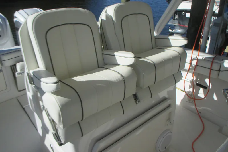  Yacht Photos Pics Luxury seating on a 2012 Jupiter 30 FS boat, featuring white cushioned chairs.