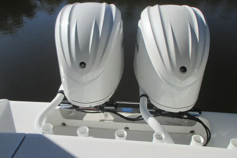  Yacht Photos Pics Twin outboard engines on a 2012 Jupiter 30 FS boat, docked on calm water.