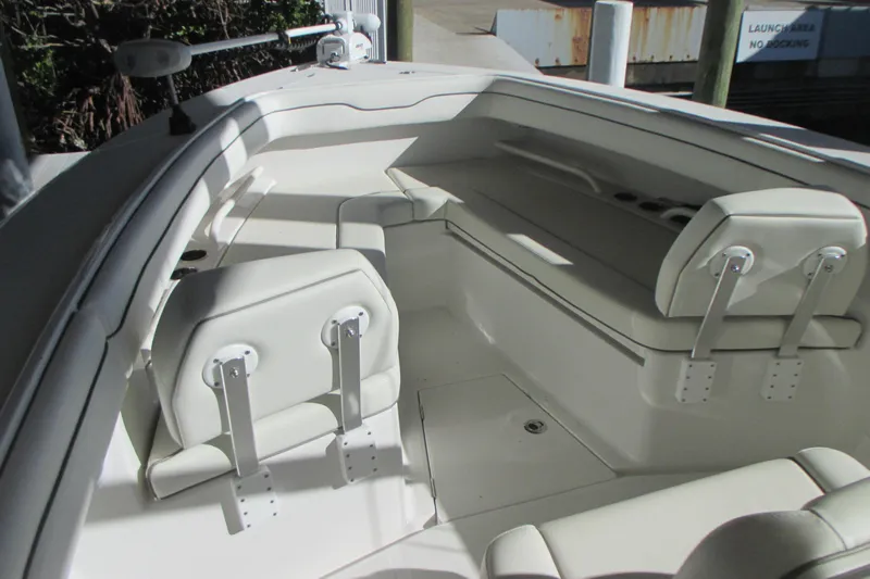  Yacht Photos Pics Interior of a 2012 Jupiter 30 FS boat with white seating and storage compartments.