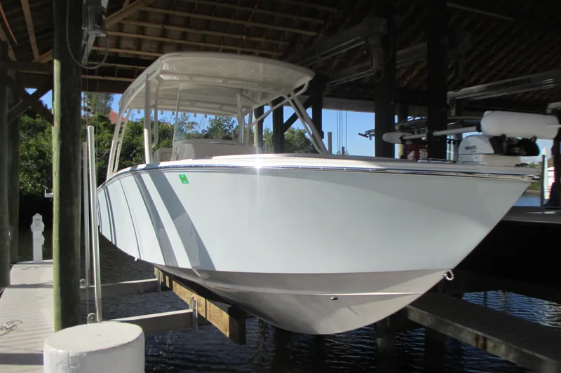  Yacht Photos Pics 2012 Jupiter 30 FS boat docked under a wooden shelter.