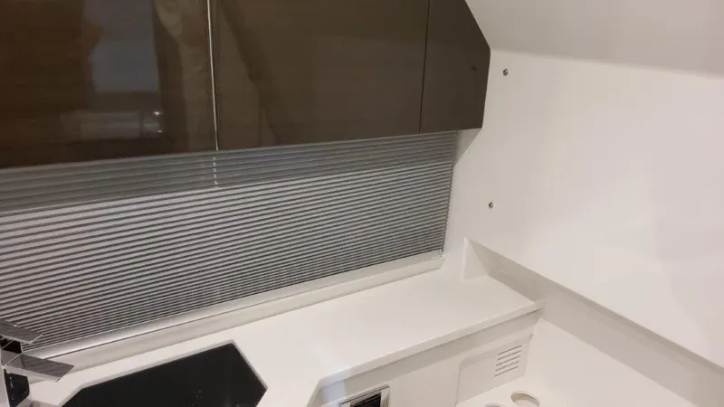  Yacht Photos Pics 2023 Formula 380 Super Sport Crossover OB interior kitchen area with modern cabinetry and countertop.