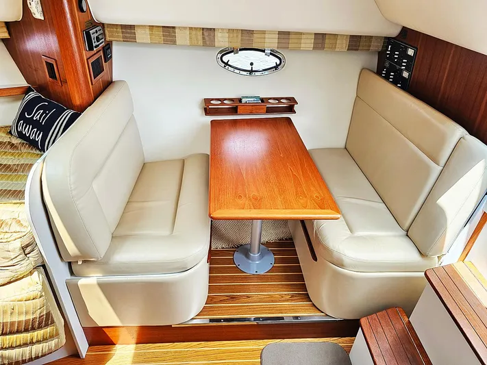 Fidgit Yacht Photos Pics 2006 Tiara Yachts 2900 Open Classic interior with beige seating and wooden table.