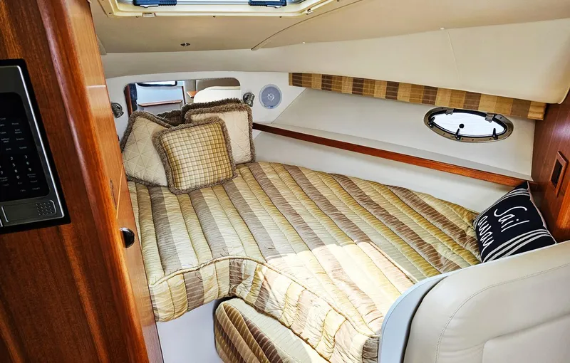 Fidgit Yacht Photos Pics 2006 Tiara Yachts 2900 Open Classic cabin with cozy bedding and wood accents.
