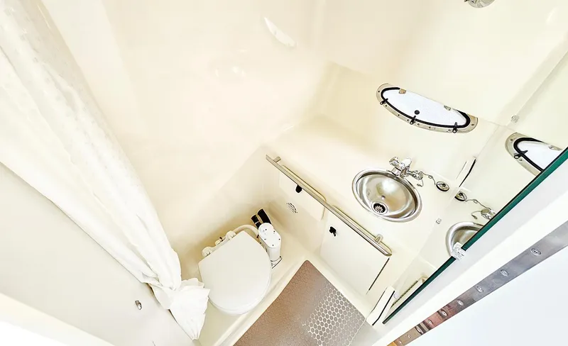 Fidgit Yacht Photos Pics 2006 Tiara Yachts 2900 Open Classic bathroom with toilet, sink, and shower.