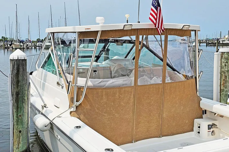 Fidgit Yacht Photos Pics 2006 Tiara Yachts 2900 Open Classic docked at marina with clear enclosure.