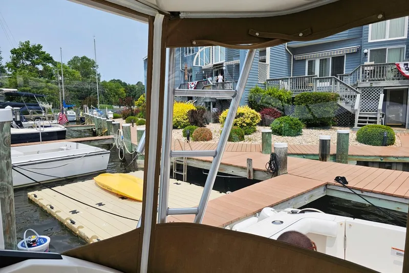 Fidgit Yacht Photos Pics 2006 Tiara Yachts 2900 Open Classic docked near waterfront homes and boats.