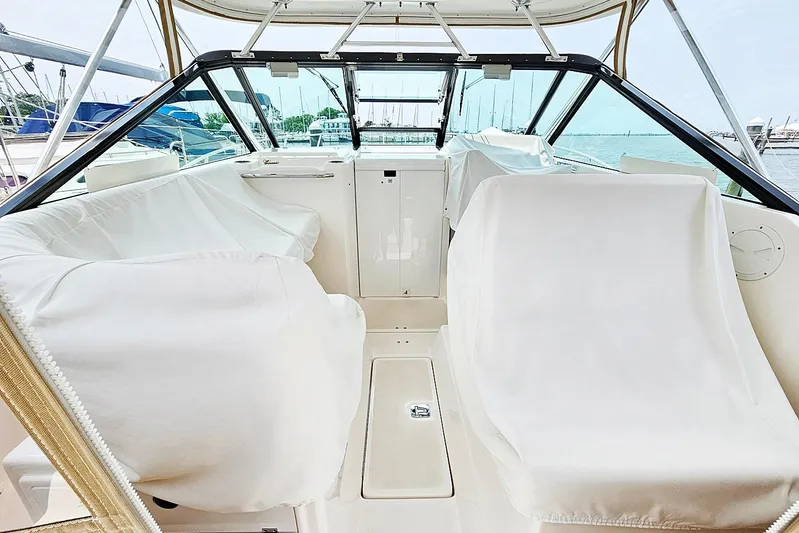 Fidgit Yacht Photos Pics 2006 Tiara Yachts 2900 Open Classic interior with white seating and marina view.