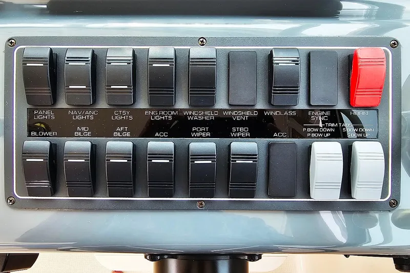 Fidgit Yacht Photos Pics Control panel of a 2006 Tiara Yachts 2900 Open Classic with labeled switches and levers.