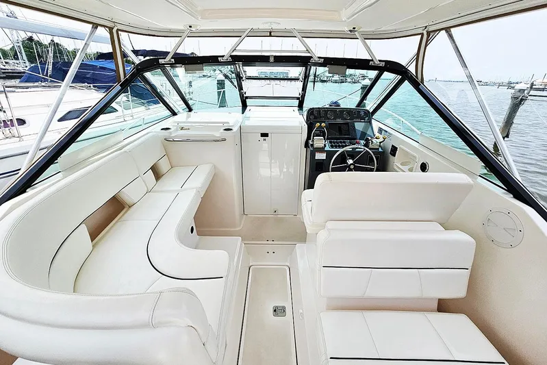 Fidgit Yacht Photos Pics 2006 Tiara Yachts 2900 Open Classic interior with white seating and helm, docked at marina.