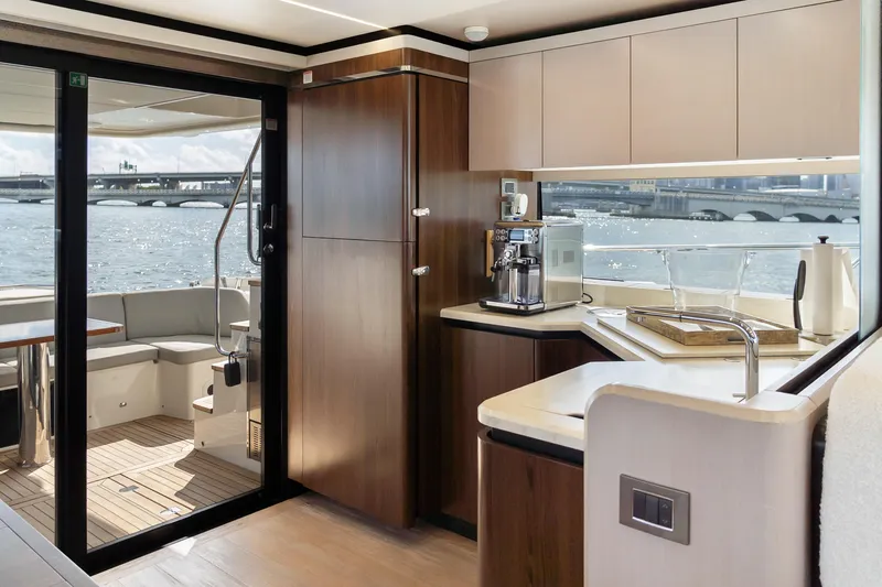 Triangle Yacht Photos Pics Luxurious interior of 2019 Absolute 58 FLY yacht with modern kitchen and scenic water view.