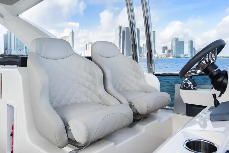 Triangle Yacht Photos Pics Luxurious seating on 2019 Absolute 58 FLY yacht with city skyline in background.