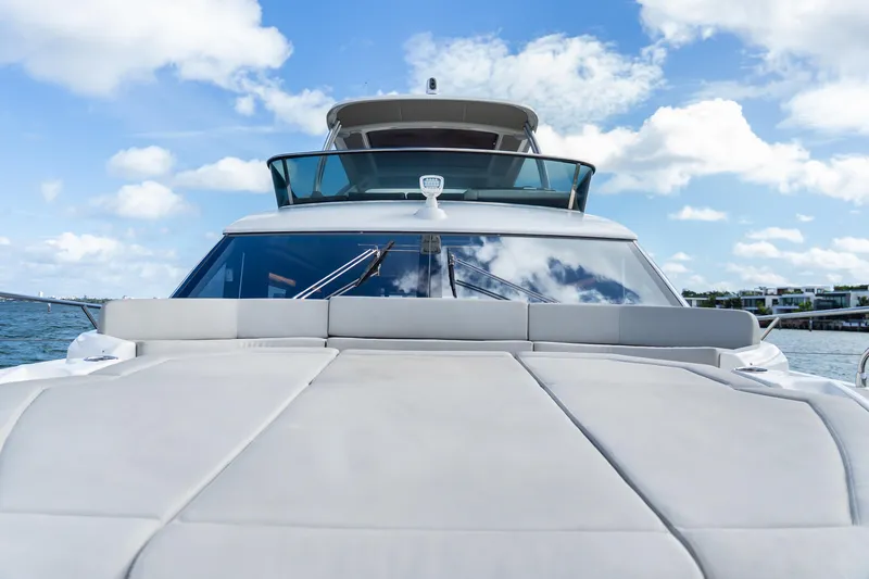 Triangle Yacht Photos Pics Luxury Absolute 58 FLY yacht, 2019 model, on open water under blue sky.