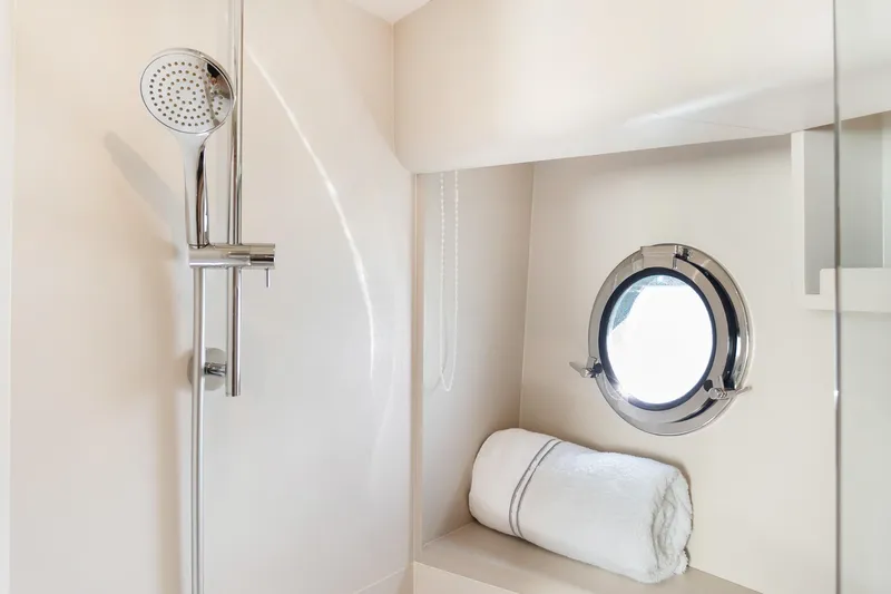 Triangle Yacht Photos Pics Luxurious bathroom in 2019 Absolute 58 FLY yacht with shower and porthole window.