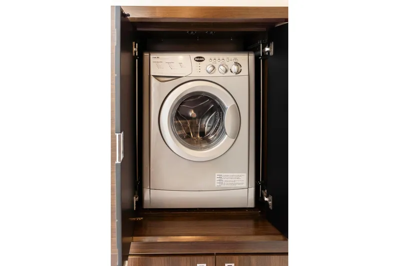 Triangle Yacht Photos Pics Front-loading washing machine in wooden cabinet on Absolute 58 FLY yacht, 2019 model.
