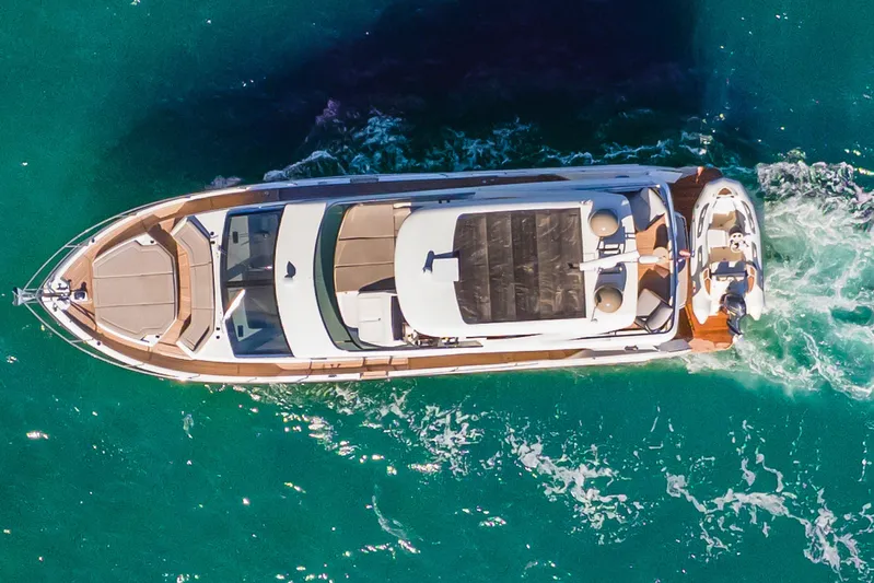 Triangle Yacht Photos Pics Aerial view of 2019 Absolute 58 FLY yacht cruising in clear turquoise waters.