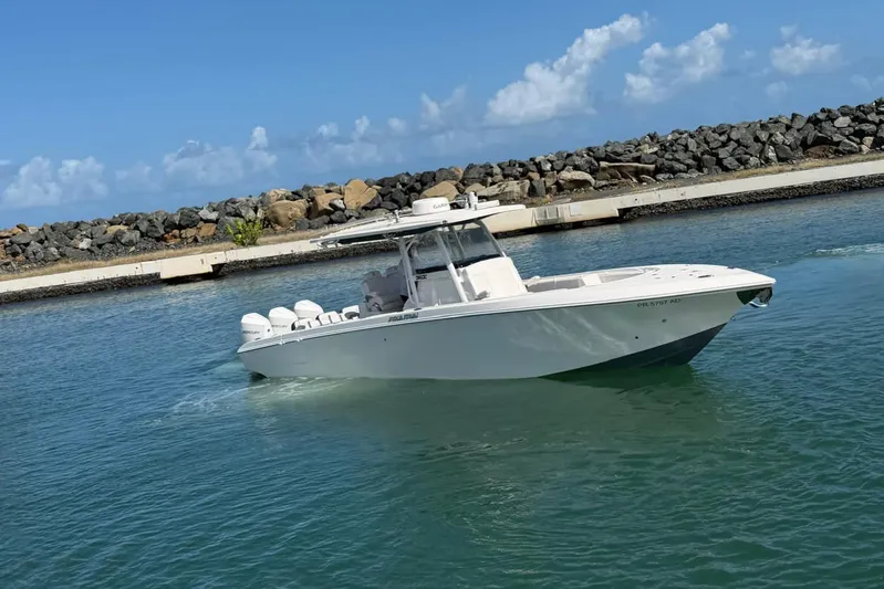  Yacht Photos Pics 2023 Fountain 34 Center Console boat cruising in a calm harbor.