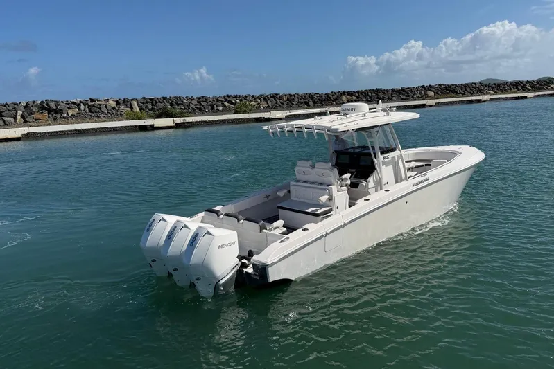  Yacht Photos Pics 2023 Fountain 34 Center Console boat with triple Mercury engines on water.