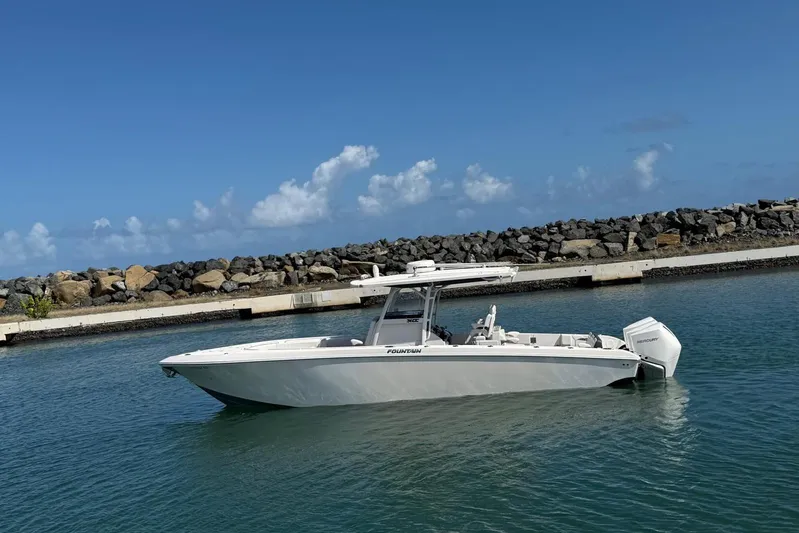  Yacht Photos Pics 2023 Fountain 34 Center Console boat in calm waters, clear sky background.