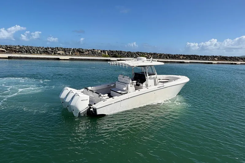  Yacht Photos Pics 2023 Fountain 34 Center Console boat cruising in clear blue waters.