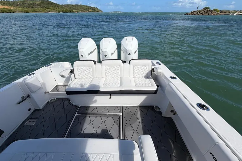  Yacht Photos Pics 2023 Fountain 34 Center Console boat with triple Mercury engines on open water.
