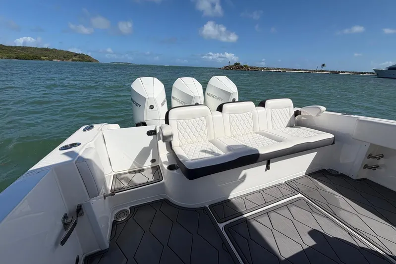  Yacht Photos Pics 2023 Fountain 34 Center Console boat with triple Mercury engines on open water.