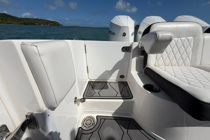  Yacht Photos Pics 2023 Fountain 34 Center Console boat interior with white seating and Mercury engines.